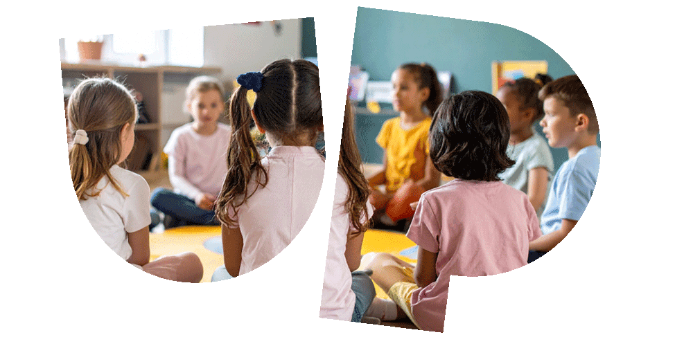 Children sitting in a circle on the floor, engaged in an activity in a brightly lit classroom.