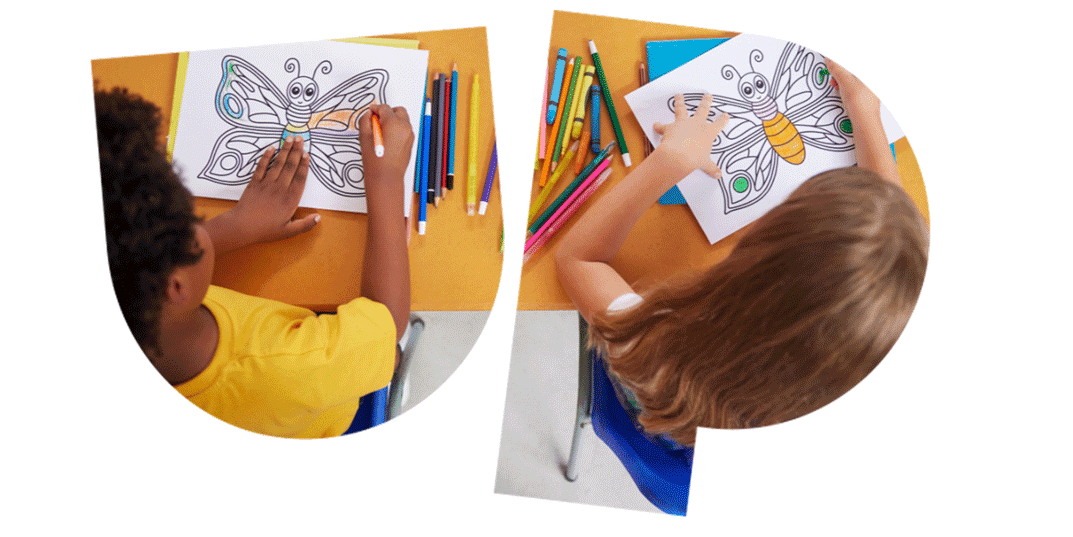 Two children coloring butterfly drawings at a desk with colored pencils scattered around.