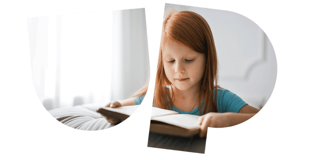 Young girl with red hair reading a book at a table, wearing a blue shirt. The image is creatively split into two overlapping shapes.